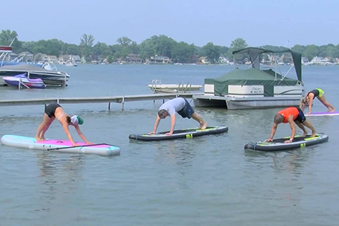 People doing Yoga on Paddle Boards