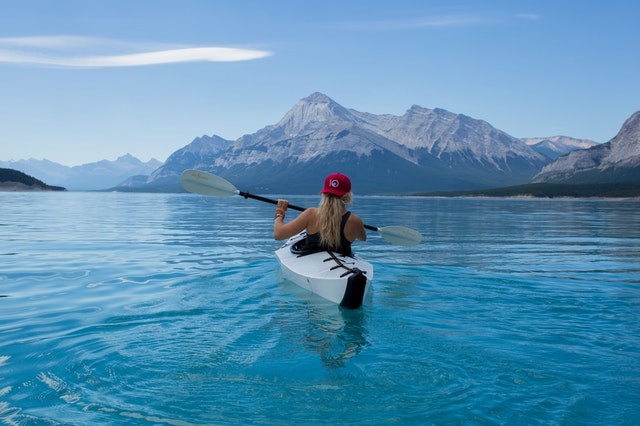 a woman paddles in a kayak